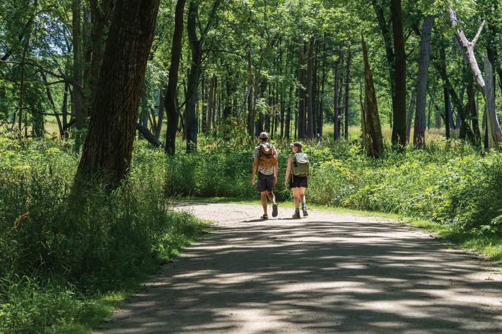 Two backpackers walk on a trail at Van Patten Woods in Wadsworth. This preserve contains 5 miles of trails open for hiking, biking, horseback riding and cross-country skiing.